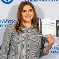 individuals smiling holding certificate